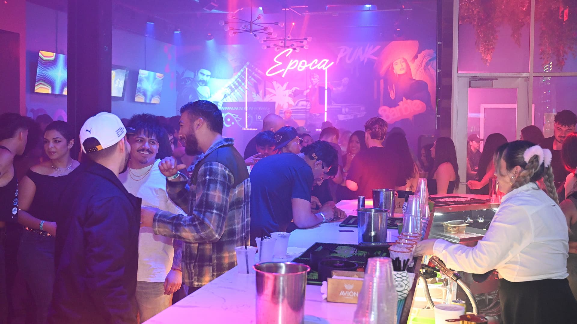 Guests at the bar on a packed night at Época Cantina