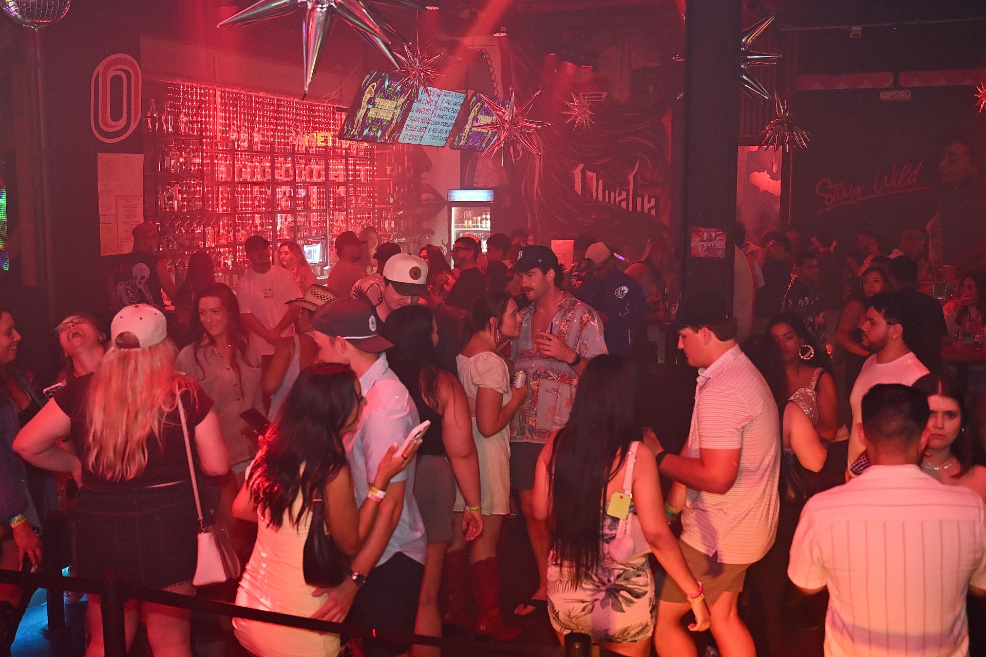 Red-lit packed room at Época Cantina in The Capitol District