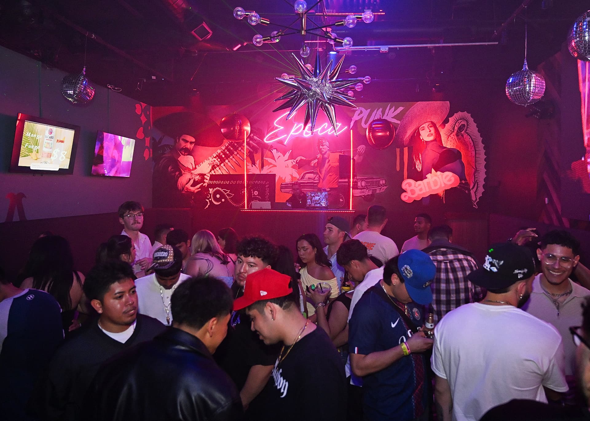 Disco balls over a full dance floor at Época Cantina